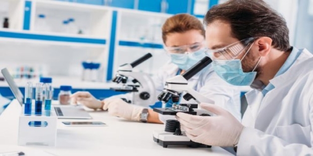 A group of people in lab coats and masks looking through microscopes

AI-generated content may be incorrect.